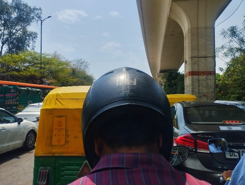 Salesman driving bike in sun, india, Traffic